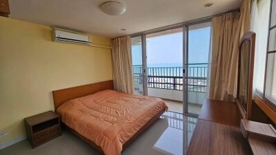 Bright bedroom with ocean view and balcony access