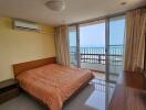 Bright bedroom with ocean view and balcony access