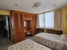 Spacious Bedroom with Twin Beds and Ample Lighting