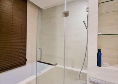 Modern bathroom with glass shower enclosure and wooden blinds