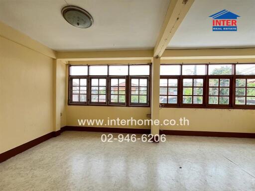 Spacious unfurnished bedroom with large windows and wooden flooring