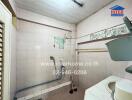 Compact tiled bathroom with basic amenities