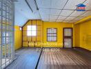 Bright bedroom with yellow walls and wooden flooring