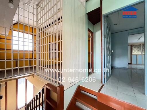 Interior view of a building showing security gate and staircase