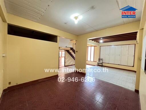 Spacious living room with staircase and ceramic tile flooring