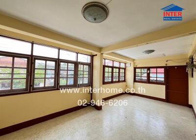 Spacious living room with large windows and ample natural light