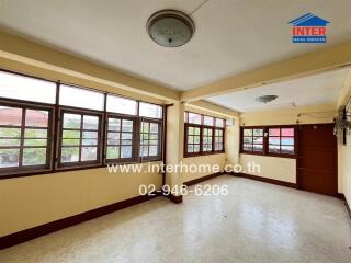 Spacious living room with large windows and ample natural light