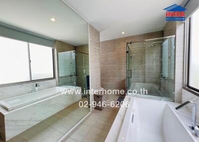 Spacious modern bathroom with large windows and luxurious fixtures