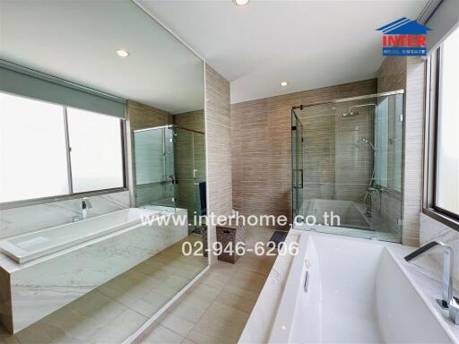 Spacious modern bathroom with large windows and luxurious fixtures