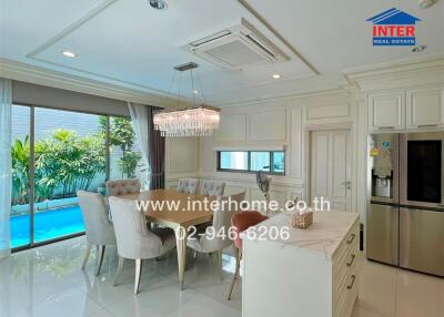 Elegant kitchen and dining area overlooking a pool