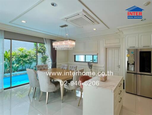 Elegant kitchen and dining area overlooking a pool