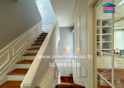 Elegant hallway interior with staircase and wooden floors