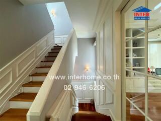 Elegant hallway interior with staircase and wooden floors