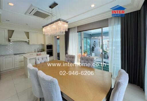 Elegant dining room with chandelier and adjacent garden view