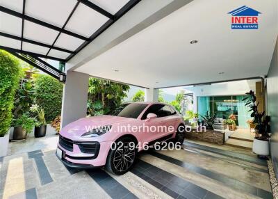 Luxurious home driveway with a modern pink sports car