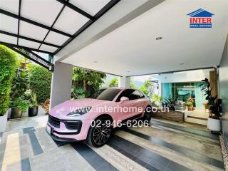 Luxurious home driveway with a modern pink sports car