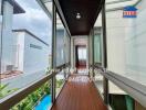 Spacious balcony with wooden flooring and glass railing