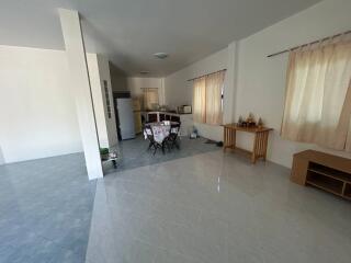 Spacious living room with adjacent kitchen and dining area