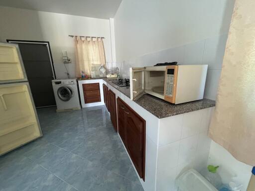 Compact kitchen with appliances and blue tile flooring