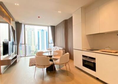 Modern kitchen with open plan living area featuring dining space and city view