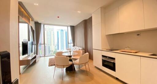 Modern kitchen with open plan living area featuring dining space and city view