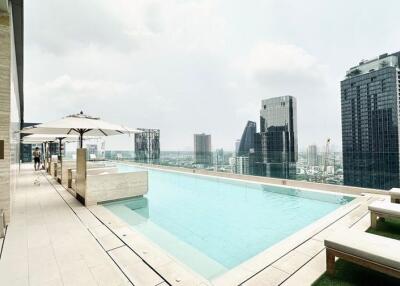 Luxury rooftop swimming pool with city skyline view