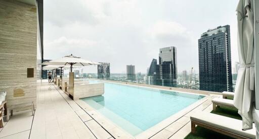 Luxury rooftop swimming pool with city skyline view