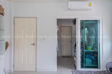 Interior view showing a doorway, air conditioning unit, and a glass door to a storage area