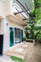 Exterior view of a modern home with large glass doors and balcony