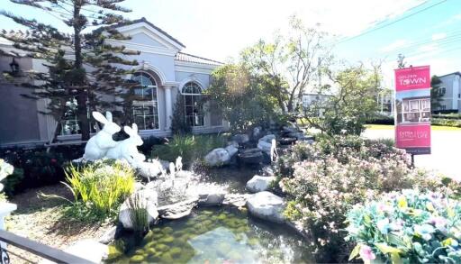 Elegant house exterior with decorative pond and statues