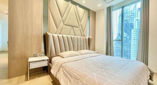 Modern bedroom with stylish headboard and city view