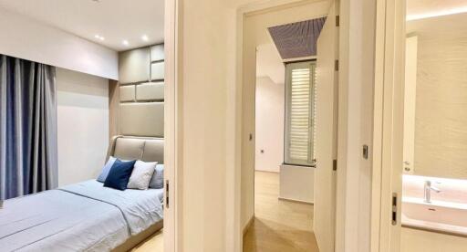 Modern bedroom with well-lit clean design and en suite bathroom
