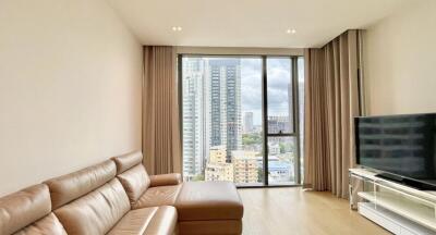 Spacious living room with large windows overlooking the cityscape