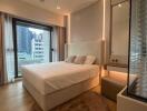 Modern bedroom with large bed, ample lighting, and city view