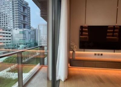 Modern living room with city view showcasing a large window and contemporary furnishings