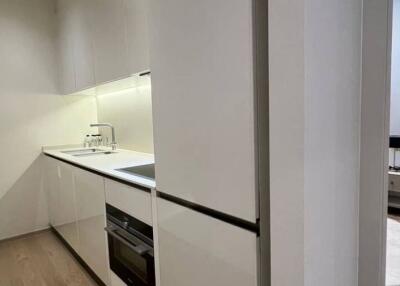 Modern kitchen with sleek design and integrated appliances adjacent to a dining area