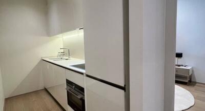 Modern kitchen with sleek design and integrated appliances adjacent to a dining area