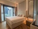 Modern bedroom with large bed and expansive city view