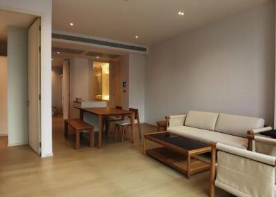 Spacious and well-lit living room leading to an open dining area