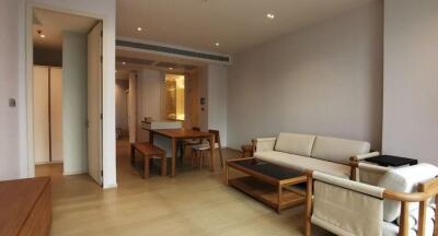 Spacious and well-lit living room leading to an open dining area