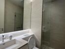 Modern bathroom with marble finishes and well-lit vanity area