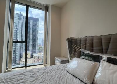 Modern bedroom with cityscape view through large window