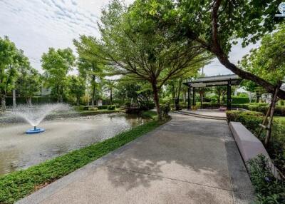 Serene outdoor garden with walking path and water fountain