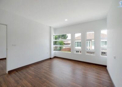 Spacious and bright empty bedroom with hardwood floors