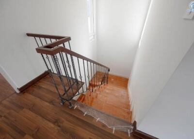 Elegant staircase with wooden flooring and modern metal railings