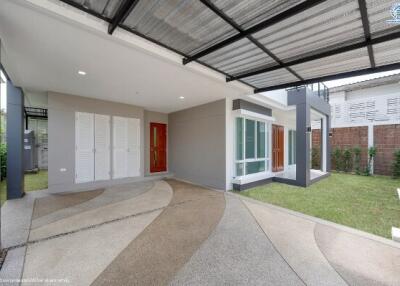 Modern home exterior with landscaped garden and curved driveway