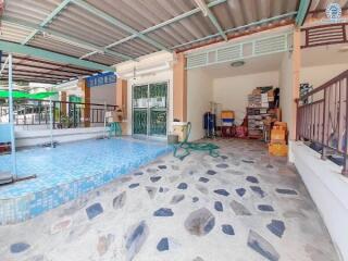 Spacious covered outdoor area with swimming pool and storage