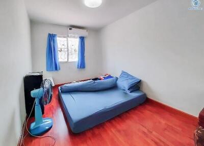 Bright and modern bedroom with red floor and blue bedding
