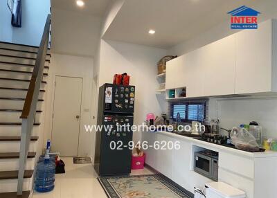 Modern kitchen with appliances and staircase