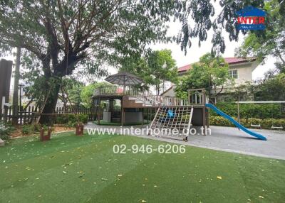Outdoor playground with play structures next to a residential building